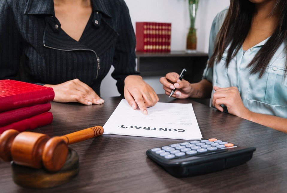 two persons signing a contract
